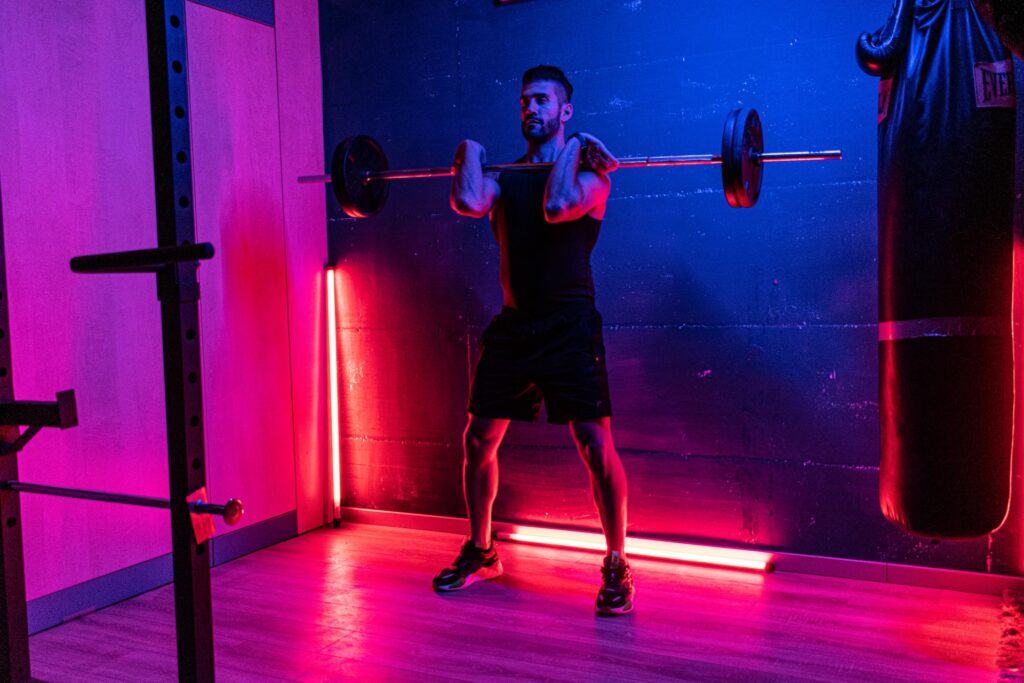 A man in the gym lifting weights and thinking about different home gym design ideas