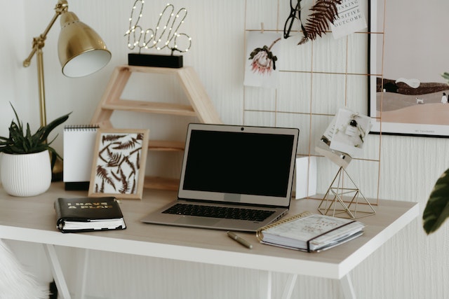 A laptop on a wooden desk in the home office