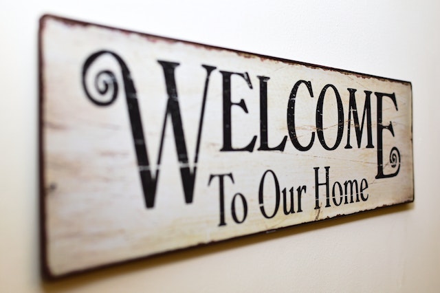 A sign “Welcome to our home” on the wall