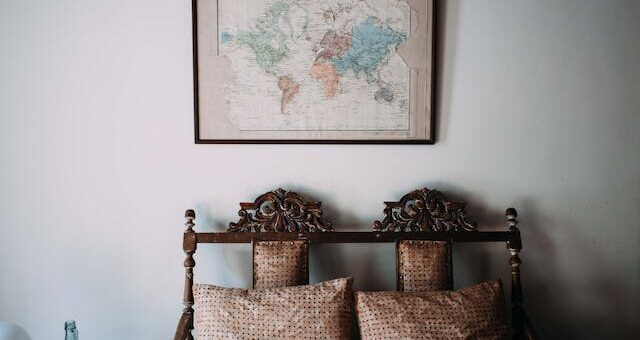 an old map above an antique loveseat is an example of decorating with found objects