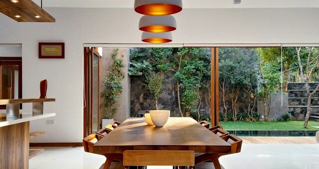 bright dining area overlooking green space outside