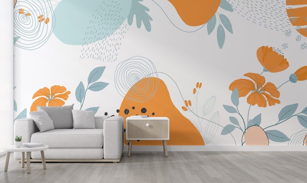 A small sofa and coffee table in front of a wall with brightly colored wallpaper.