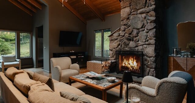 A cottage living room with a stone fireplace. Clutter